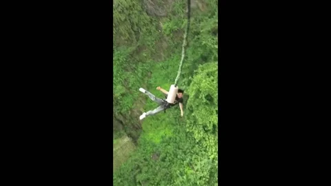 China: Man passes out while experiencing bungee jumping Stock Footage 276309874