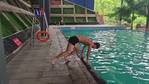 China: Man slips and falls into indoor pool while attempting dive in Guan... Stock Footage 336621432