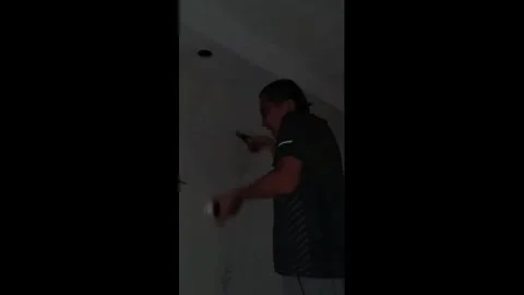 China: Man startled by electrical spark while changing light bulb in Hube... Stock Footage 344041228
