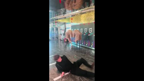 China: Man trips over his own feet and falls in Henan, China Stock Footage 331294388