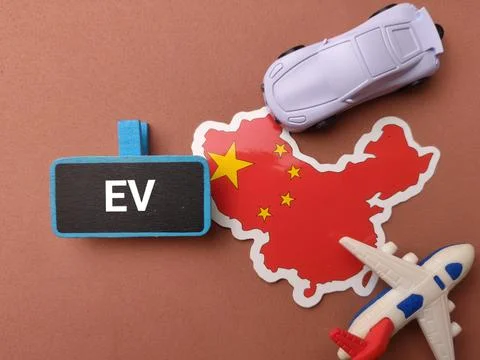 A China map sticker is surrounded by a toy car, a toy plane, and a sign lab.. Stock Photos