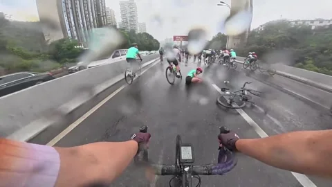 China: Mass crash caught on camera during rain-soaked bike race in China Stock Footage 322147221