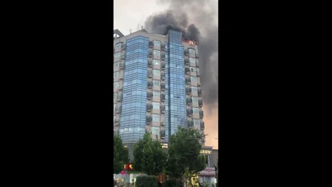 China: Massive fire engulfs top of building in Henan, China Stock Footage 337088690