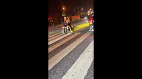 China: Mishap on motorcycle causes fall at traffic stop in Hunan, China Stock Footage 336711421