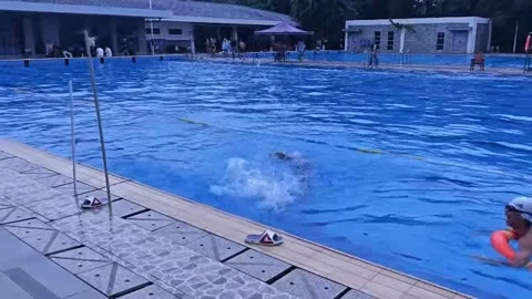 China: Mock rescue attempt ends in slip and fall at swimming pool in Sich... Stock Footage 337524201