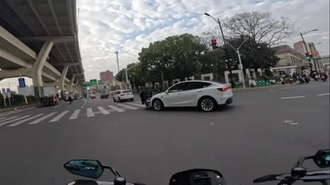China: Motorcycle struck by car during turn in Shanghai, China Stock Footage 330073325