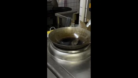 China: Mouse struggles to escape slippery wok in Jilin, China Stock Footage 336003752
