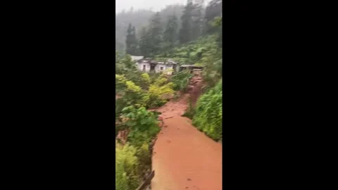 China: Mudslide and severe flooding engulf mountain road in Yunnan, China... Stock Footage 343960418
