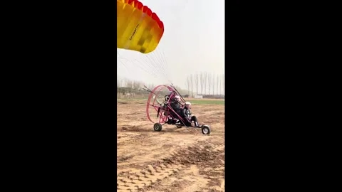 China: Powered parachute takes off with two riders in Henan, China Video stock 330611997