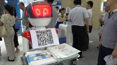 China robotics industry, serving robot offers flyers magazines at trade show Video stock 61270436