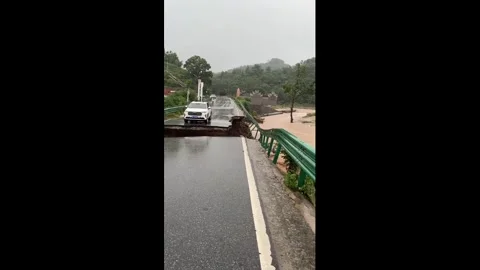 China: SUV swept into floodwaters after bridge collapse in Xiong'an, Hebe... Stock Footage 335762826