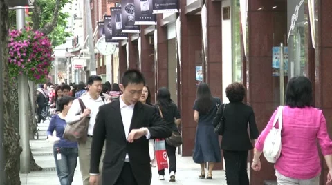 China, 'time is money', young man in business suit looks at watch Stock Footage