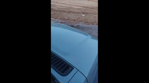 China: Wheel loader gets stuck while attempting to rescue car from mud in... Stock Footage 336573289