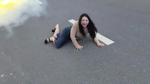 China: Woman trips while running from firecrackers in Henan, China Stock Footage 337899273