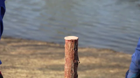 China Worker using a hammer to smash a wooden pile to install a wooden pile Stock Footage 240202579