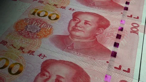 China Yuan banknotes emerging from the money press Stock Footage