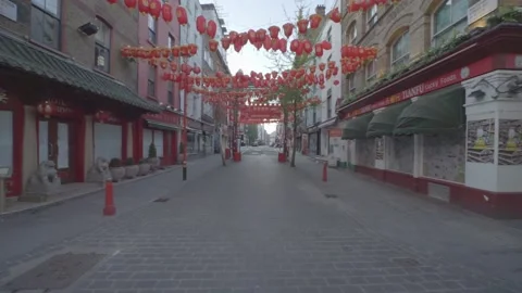 Chinatown exiting red gate to empty road, during lockdown Stock Footage 135336610