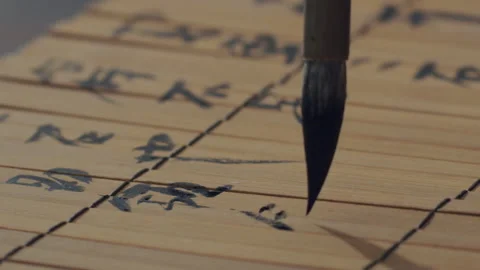 Chinese Art Of Calligraphy, Write with a brush on bamboo slips，china Stock Footage 140136877