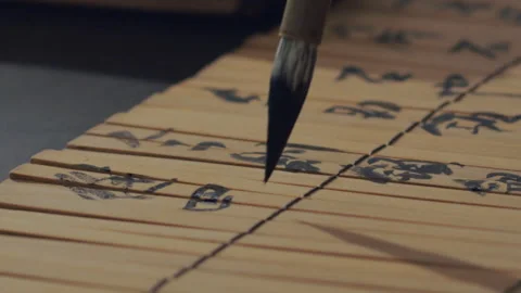 Chinese Art Of Calligraphy, Write with a brush on bamboo slips，china Stock Footage 140137356