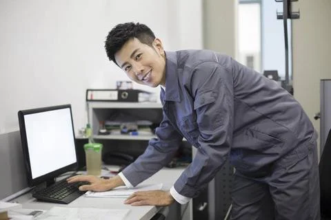  Chinese auto mechanic working with computer Beijing China Copyright: xLan... Stock Photos