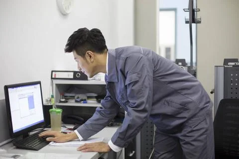 Chinese auto mechanic working with computer Beijing China Copyright: xLan... Stock Photos