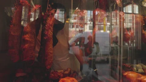 Chinese BBQ hanging in a display window, BBQ pork, BBQ duck, BBQ chicken Stock Footage 219783272