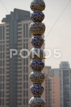 Chinese bowls in ceramic with beautiful drawings and residential buildings in th Stock Photos