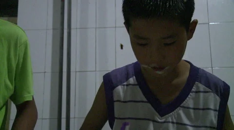 Chinese boy brushing teeth at bedtime Stock Footage 58606346