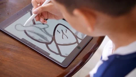 Chinese boy drawing on digital tablet Stock Footage 195839528