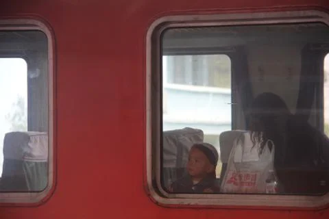 A Chinese Boy inside the train. Looking the window. China Railway Trip. 12th Stock Photos