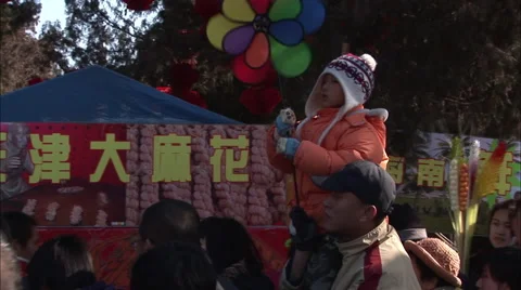Chinese boy with a wind mobile &amp; his father Stock Footage 56637169