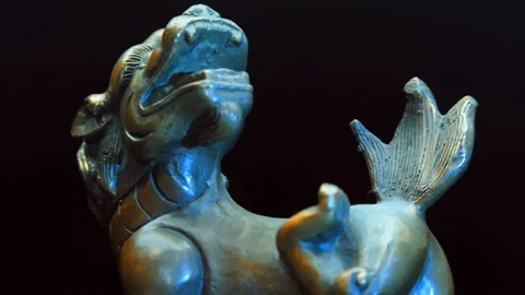 Chinese bronze cup with many embossed dragons rotates on a black background Stock Footage 121594641