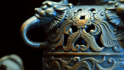 Chinese bronze cup with many embossed dragons rotates on a black background Stock Footage 121594886
