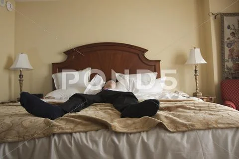 Chinese Businessman Sleeping In Hotel Bed
