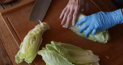 Chinese cabbage leaves lined up and chopped with chinese cleaver knife Stock Footage 329968232