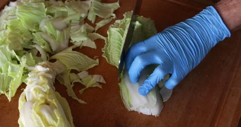 Chinese cabbage leaves lined up chopped with chinese cleaver knife Stock Footage 329968054