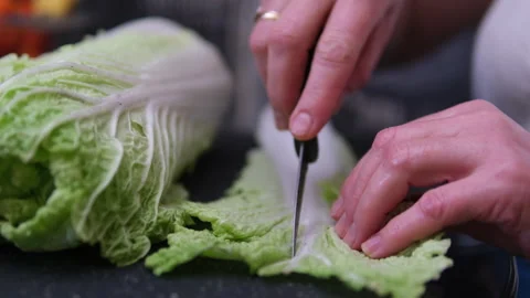 Chinese cabbage slices on a baking sheet covered with baking paper. Stock Footage 302595764