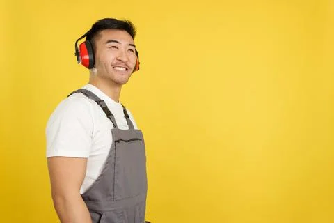 Chinese carpenter smiling distracted while looking up Stock Photos