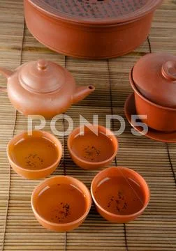 Chinese ceramic tea set and cups on white background. Stock Photos
