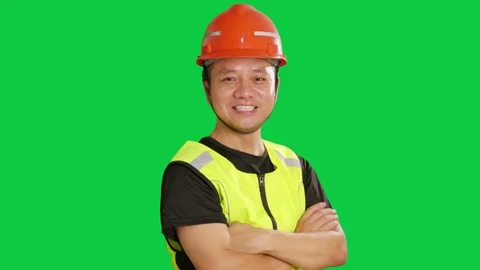 Chinese construction worker with red safety hard hat smiles toward camera. Stock Footage 343606318