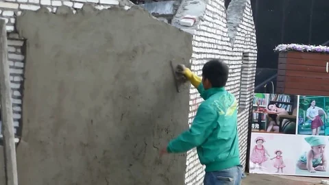 Chinese construction workers daub cement on walls Video stock 70690839