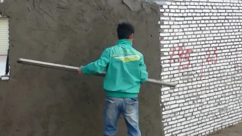 Chinese construction workers daub cement on walls Stock Footage 70690899