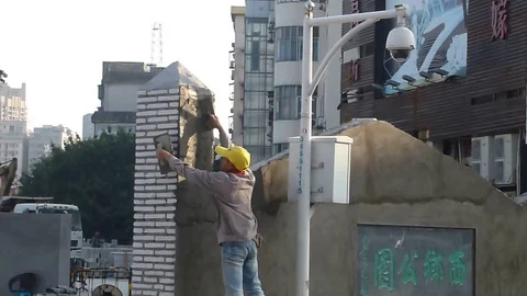 Chinese construction workers daub cement on walls Stock Footage 70691090