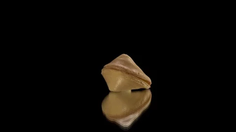 Chinese cookie rotate on a black background. Traditional fortune cookie. Stock Footage 124281750