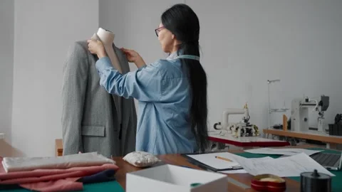 Chinese dressmaker sewing classical jacket in fashion atelier, working studio Video stock 282359756