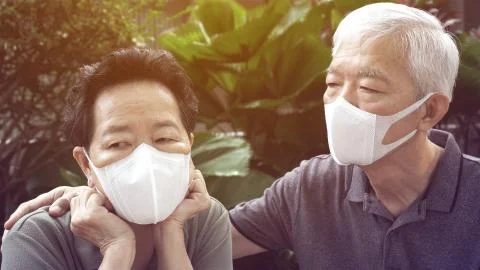 Chinese elderly couple prevent Coronavirus contamination wearing mask all tim Stock Photos