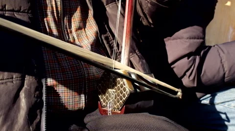 Chinese elderly man playing Chinese traditional musical instrument erhu Stock Footage 44986342