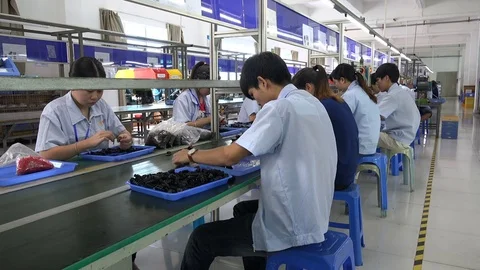 Chinese employees of electronics factory work on conveyor belt Stock-Footage 85453142