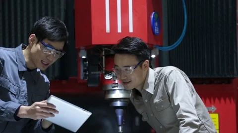 Chinese engineers using digital tablet in factory,HD Stock Footage 117904282