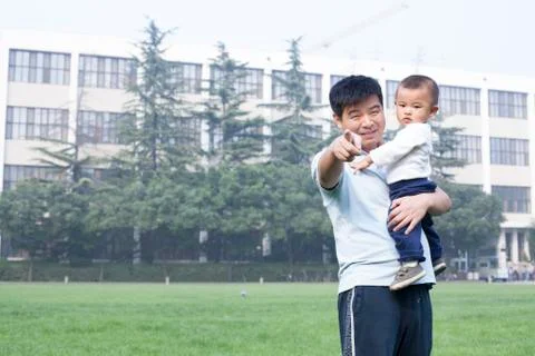 Chinese father and son pointing at camera Stock Photos